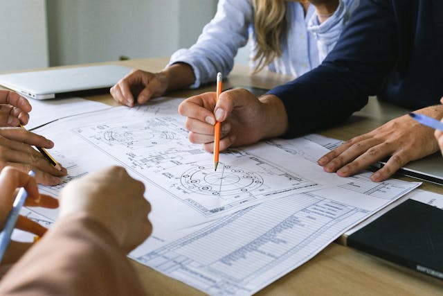 people working on an engineering schematic